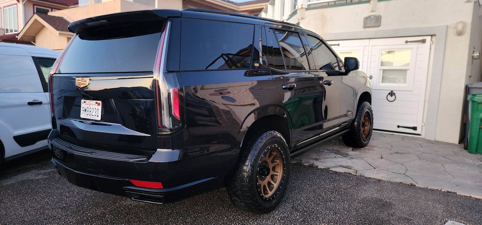 Black Cadillac Escalade rear exterior detail with bronze off-road wheels by VS Mobile Detail